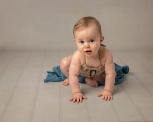 Baby crawling forward during baby photography session by Glasgow photographer