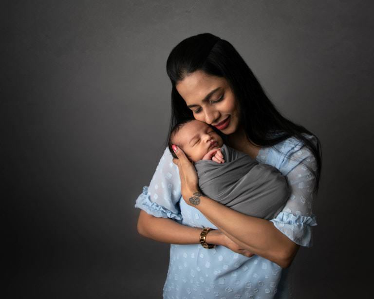 Mum holding newborn baby taken at photoshoot by photographer in Glasgow