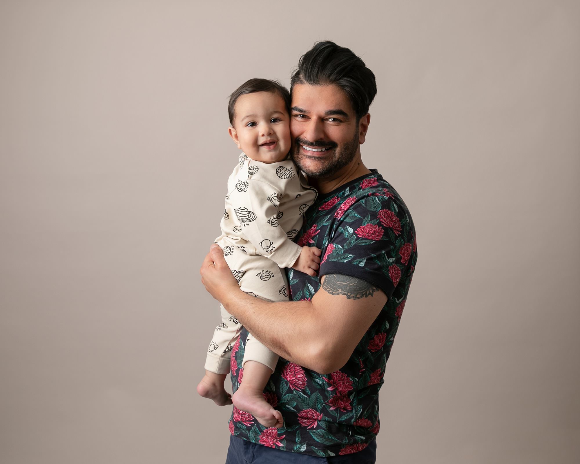 Baby boy with both Dad at photoshoot